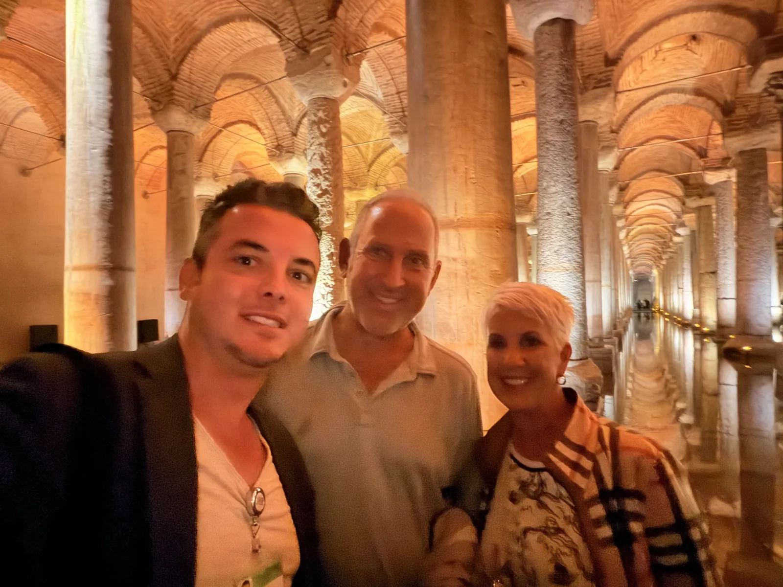 Guide Akın Güzel with two guests among the illuminated columns of the Basilica Cistern, Istanbul