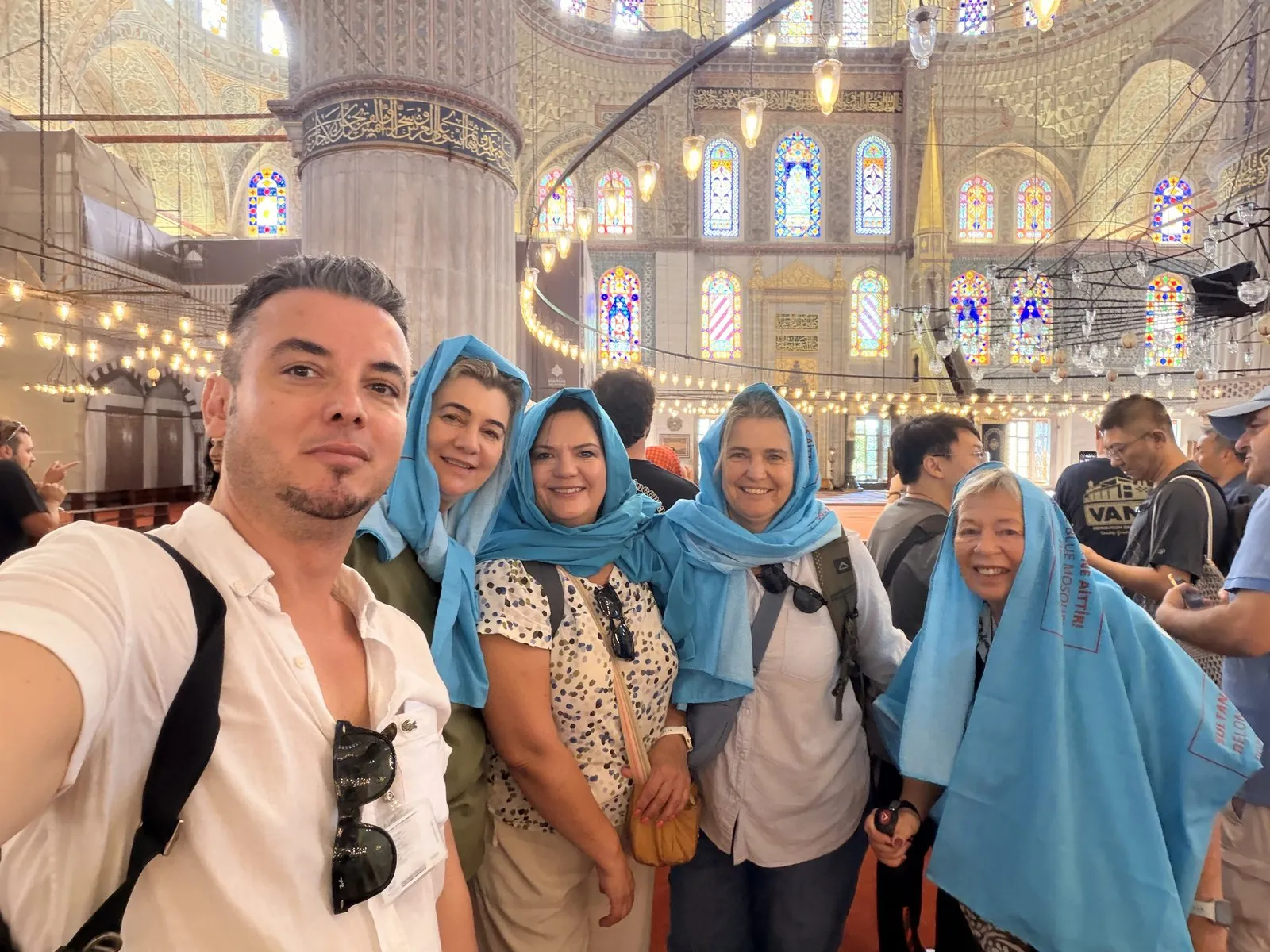 Akın Güzel with five guests under the stained-glass windows of the Blue Mosque, Istanbul