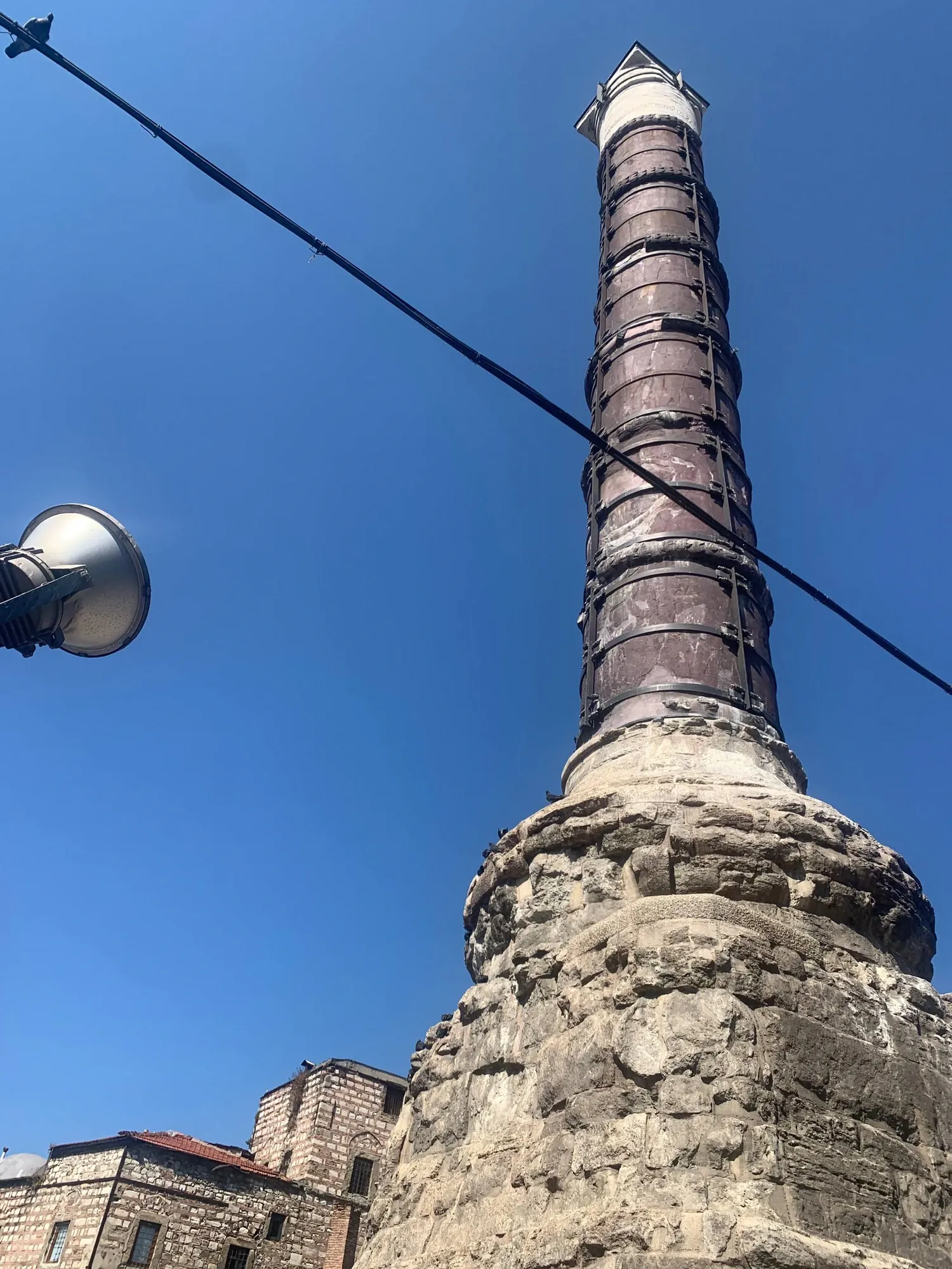 The ancient Column of Constantine (Çemberlitaş) against a blue sky in Istanbul