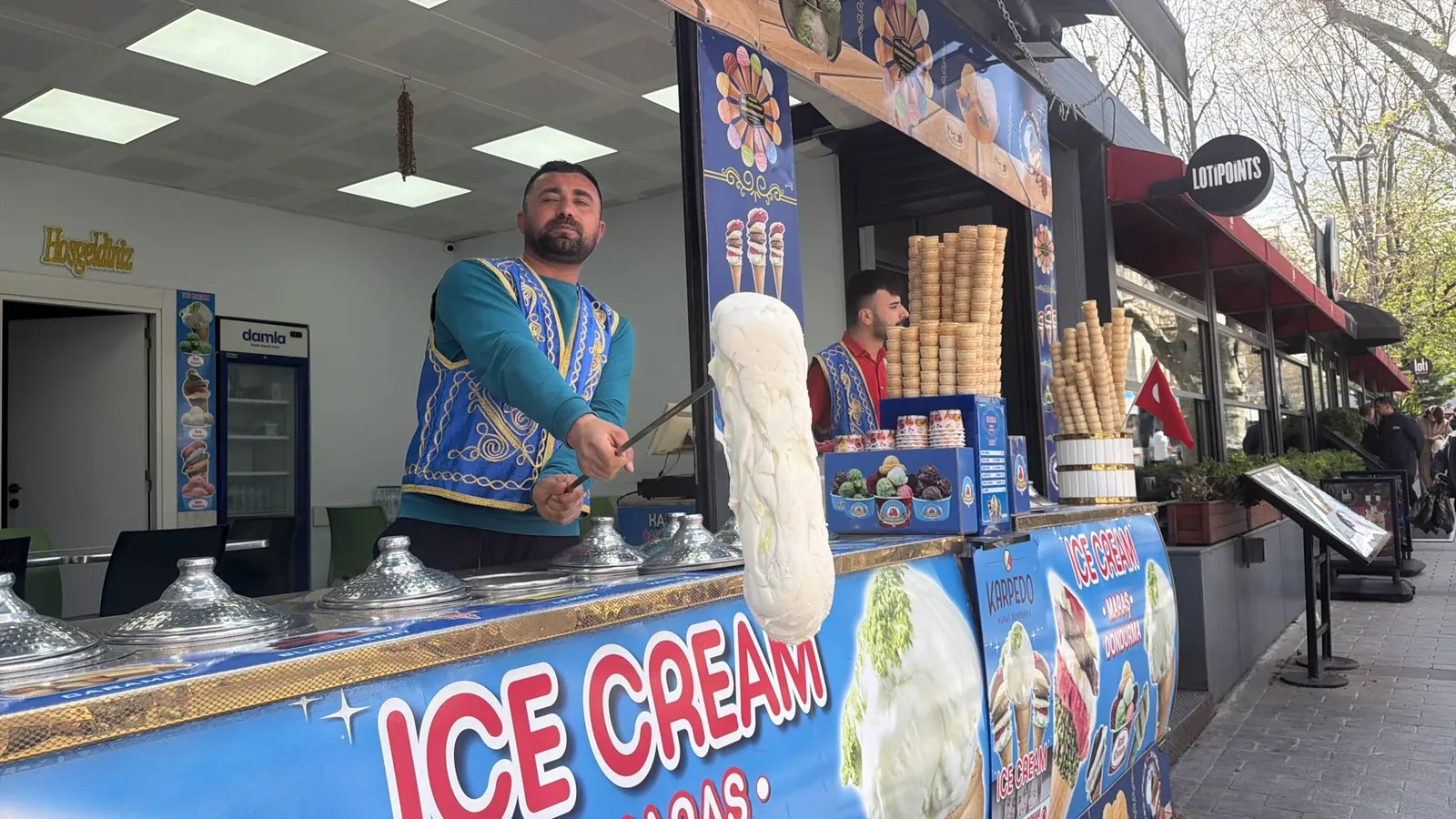 Traditional Maraş ice cream vendor performing for tour guests in Istanbul